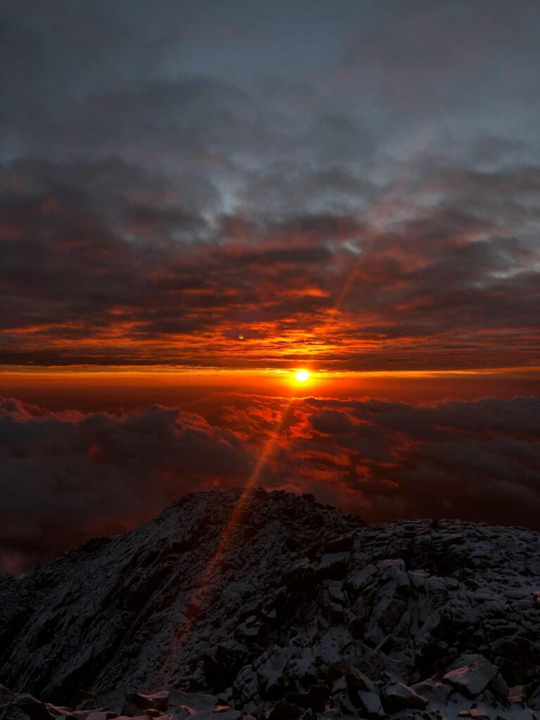 Stunning sunrise above Pikes Peak, capturing vibrant colors over the mountain landscape.
